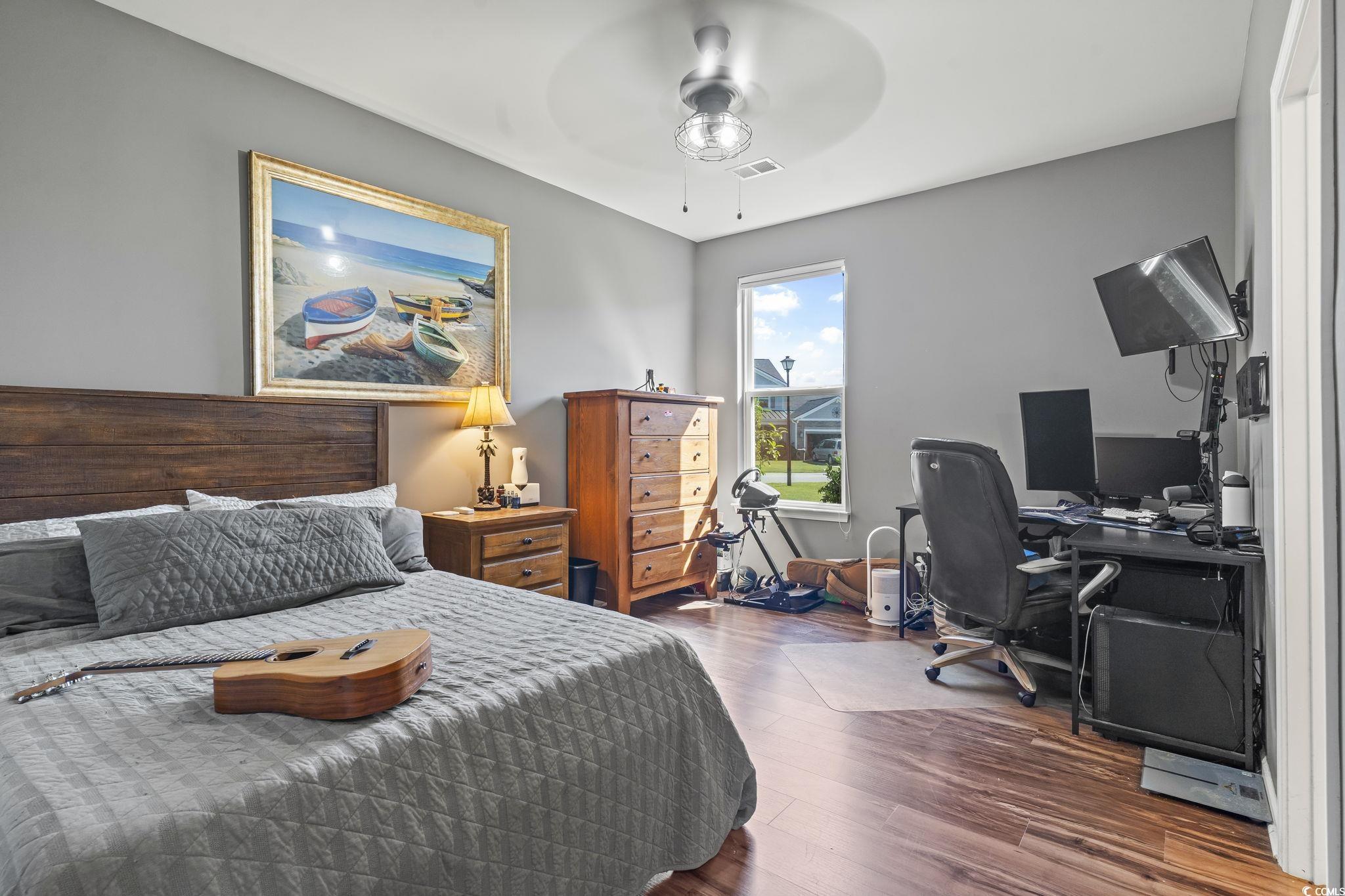 256 Copper Leaf Drive Myrtle Beach, SC 29588 - Photo 18 of 40 Bedroom featuring a desk, dark wood-type flooring, and a ceiling fan