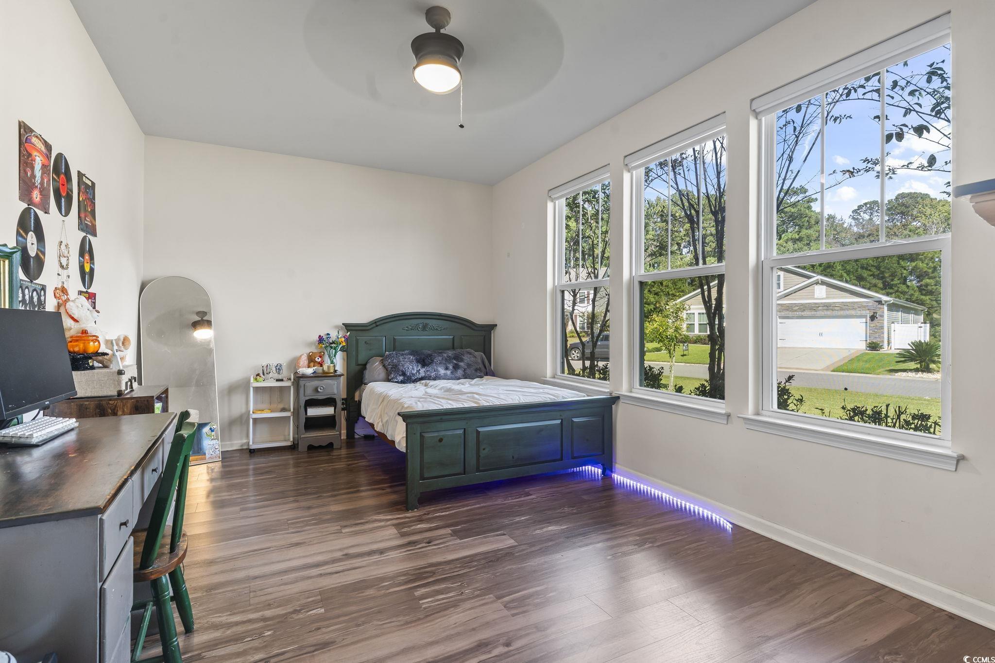 256 Copper Leaf Drive Myrtle Beach, SC 29588 - Photo 22 of 40 Bedroom with dark wood-style flooring, ceiling fan, and arched walkways