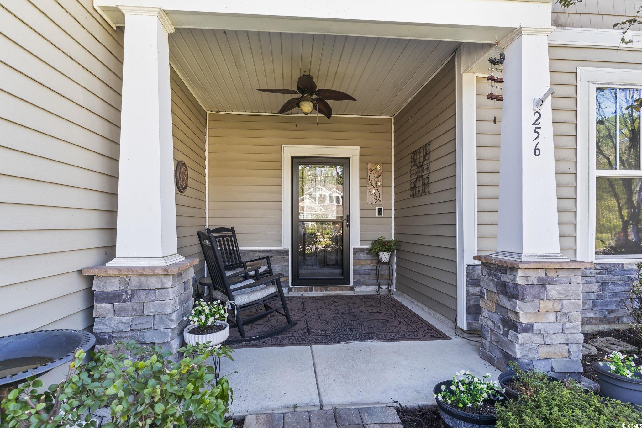 256 Copper Leaf Drive Myrtle Beach, SC 29588 - Photo 26 of 40 Doorway to property with covered porch, ceiling fan, and stone siding