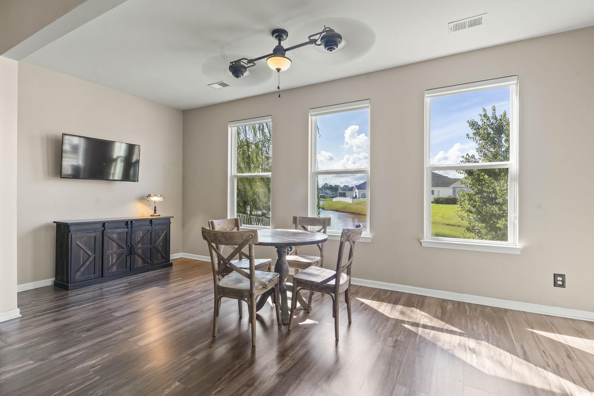 256 Copper Leaf Drive Myrtle Beach, SC 29588 - Photo 9 of 40 Dining area featuring dark wood-style flooring and baseboards