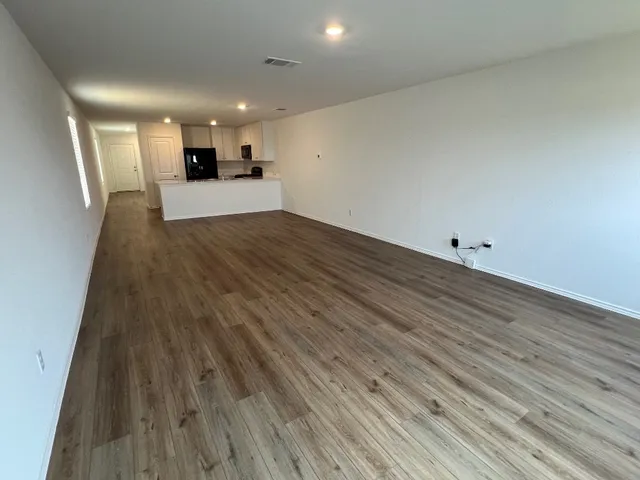 a view of a kitchen with wooden floor and a sink