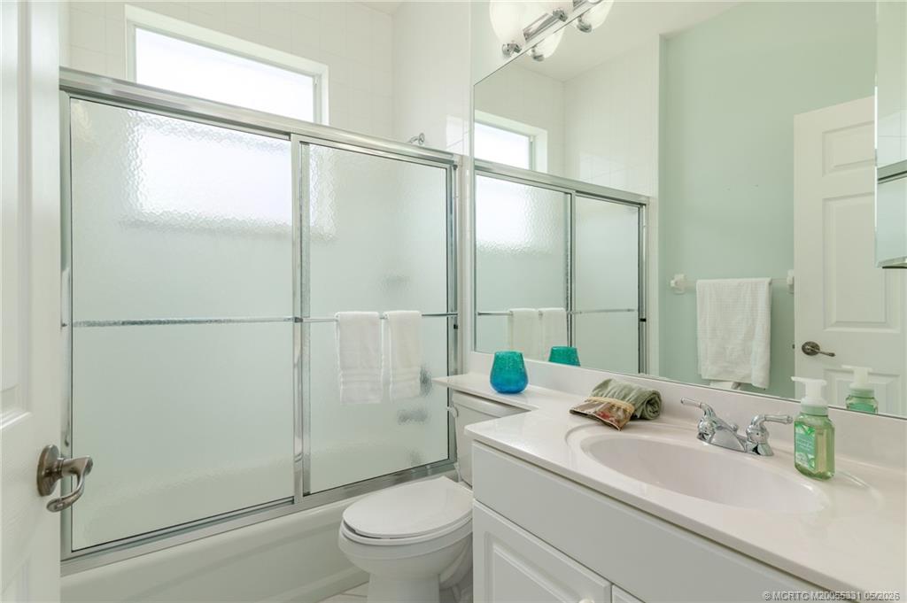 2216 Southeast Stonehaven Road Port St. Lucie, FL 34952 - Photo 24 of 67 a bathroom with a sink toilet and shower