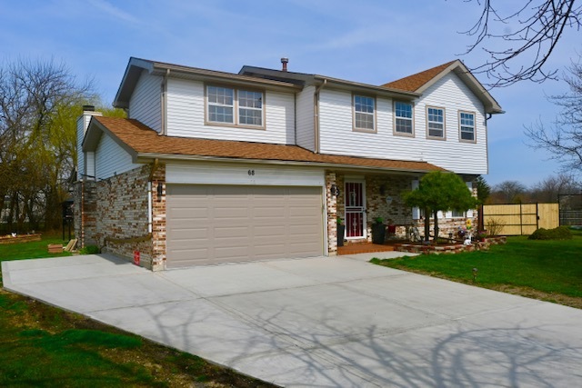 68 White Oaks Road Matteson, IL 60443 - Photo 1 of 39 a front view of a house with a yard and garage