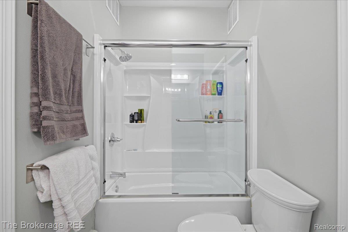 261 Reymont Road Waterford, MI 48327 - Photo 23 of 49 White fiberglass shower-tub combination featuring a sliding glass door