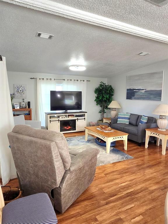 6513 Oregon Street Bradenton, FL 34207 - Photo 12 of 57 a living room with furniture and a flat screen tv