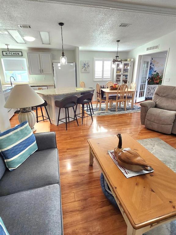 6513 Oregon Street Bradenton, FL 34207 - Photo 15 of 57 a living room with furniture and wooden floor