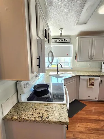 a kitchen with stainless steel appliances granite countertop a sink and cabinets