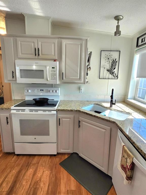 6513 Oregon Street Bradenton, FL 34207 - Photo 21 of 57 a kitchen with stainless steel appliances granite countertop a sink and cabinets