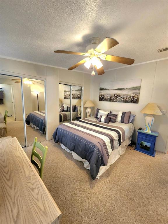6513 Oregon Street Bradenton, FL 34207 - Photo 24 of 57 a bedroom with two beds and a chandelier