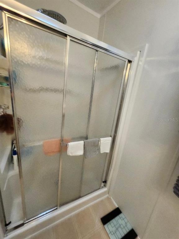 6513 Oregon Street Bradenton, FL 34207 - Photo 26 of 57 a bathroom with a glass shower door