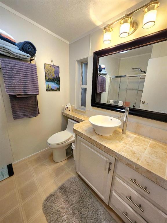 6513 Oregon Street Bradenton, FL 34207 - Photo 27 of 57 a bathroom with a granite countertop sink a toilet a mirror and bathtub