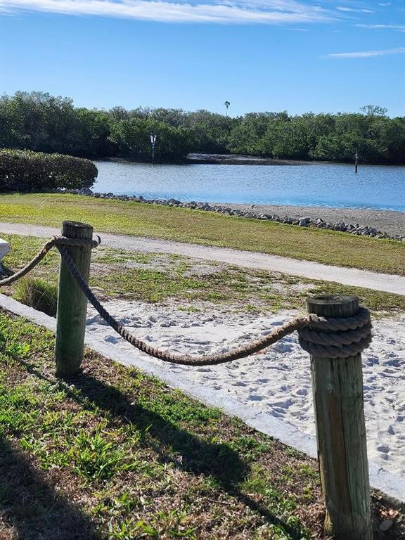 6513 Oregon Street Bradenton, FL 34207 - Photo 37 of 57 a view of a lake with a yard and palm trees
