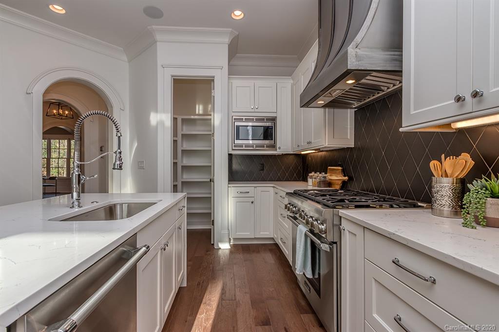 744 Ellsworth Road, Unit 46 Charlotte, NC 28211 - Photo 12 of 31 a kitchen with a stove and a sink