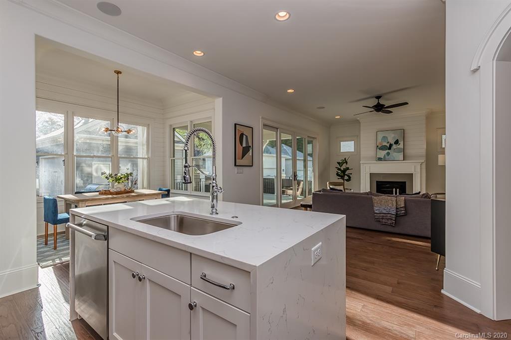 744 Ellsworth Road, Unit 46 Charlotte, NC 28211 - Photo 13 of 31 a view of living room kitchen with a sink and chandelier