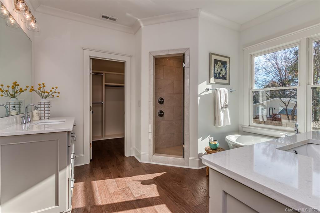 744 Ellsworth Road, Unit 46 Charlotte, NC 28211 - Photo 24 of 31 a spacious bathroom with a sink a mirror and a shower