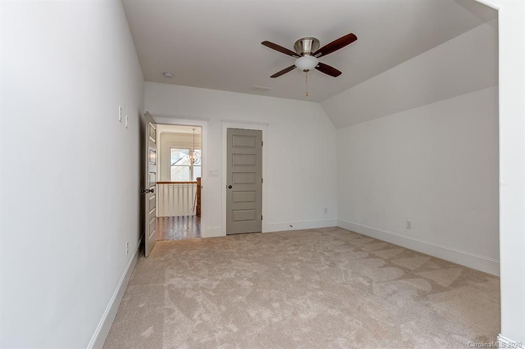 744 Ellsworth Road, Unit 46 Charlotte, NC 28211 - Photo 27 of 31 an empty room with ceiling fan and windows