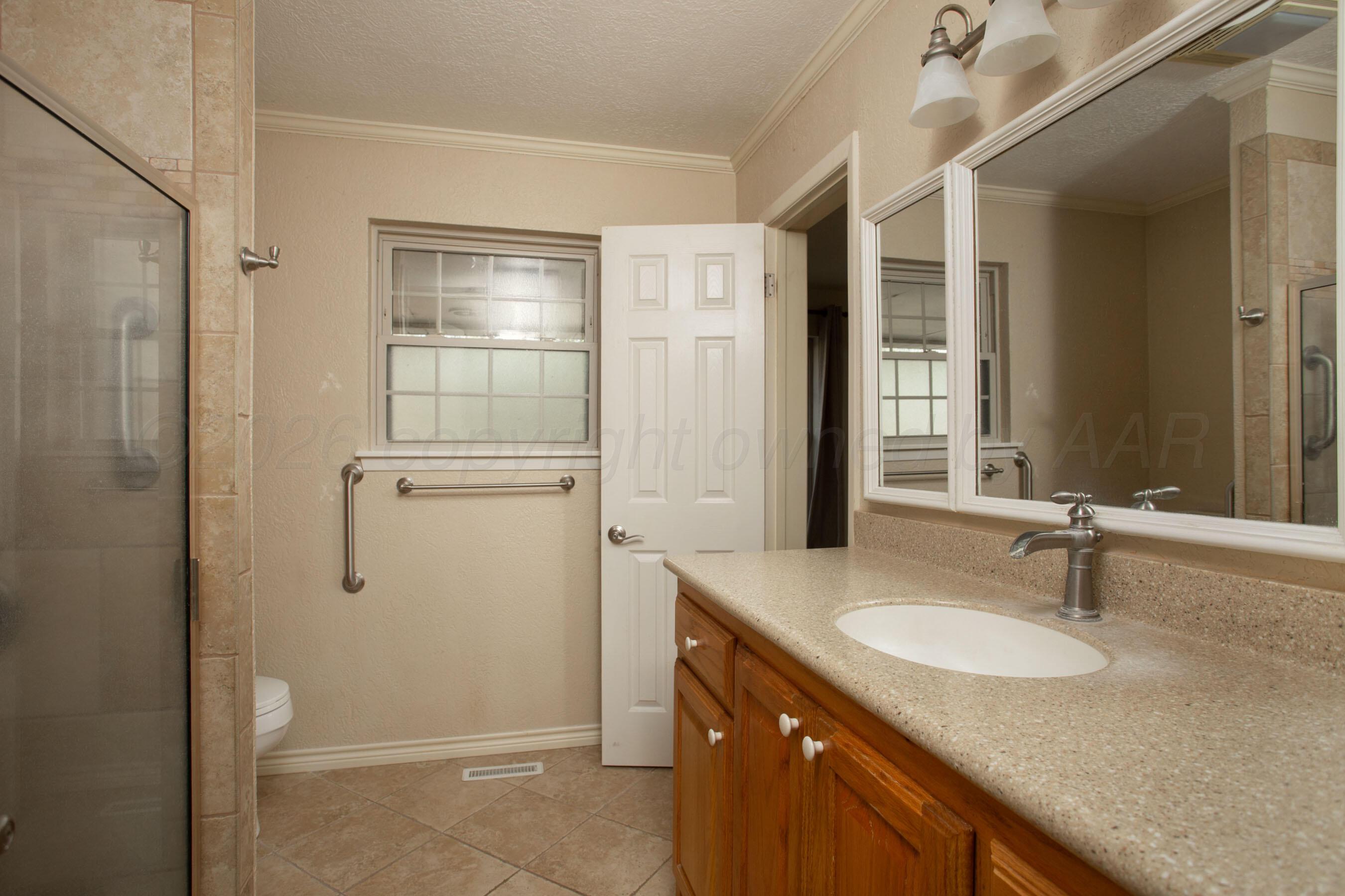 116 Dewey Avenue Amarillo, TX 79124 - Photo 14 of 35 a bathroom with a granite countertop sink and mirror