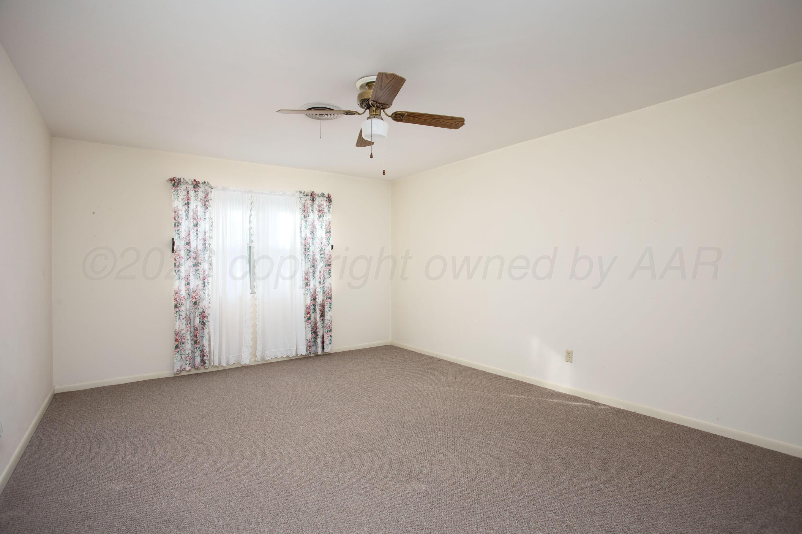 116 Dewey Avenue Amarillo, TX 79124 - Photo 21 of 35 an empty room with a ceiling fan and window