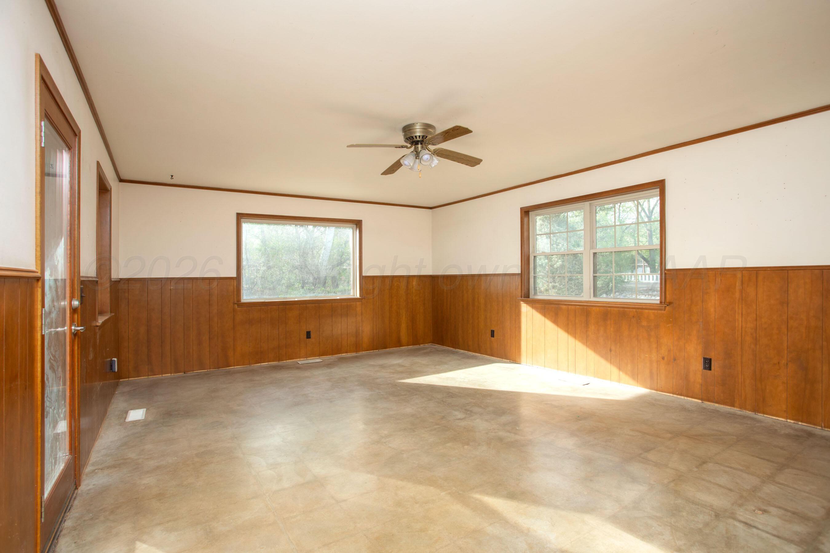 116 Dewey Avenue Amarillo, TX 79124 - Photo 10 of 35 an empty room with windows and fan