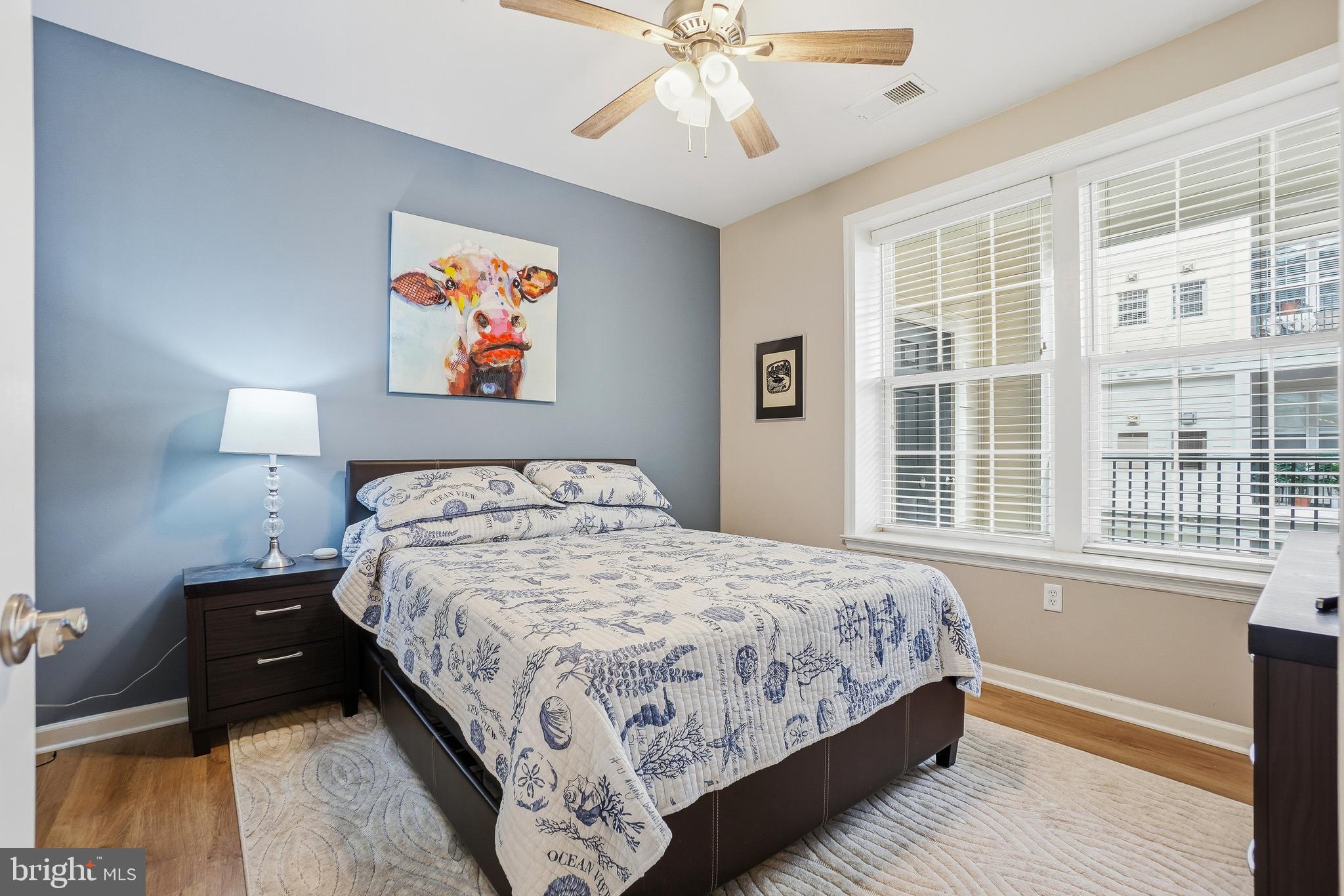 27 Booth Street, Unit 345 Gaithersburg, MD 20878 - Photo 24 of 40 a bedroom with a large bed and a chandelier