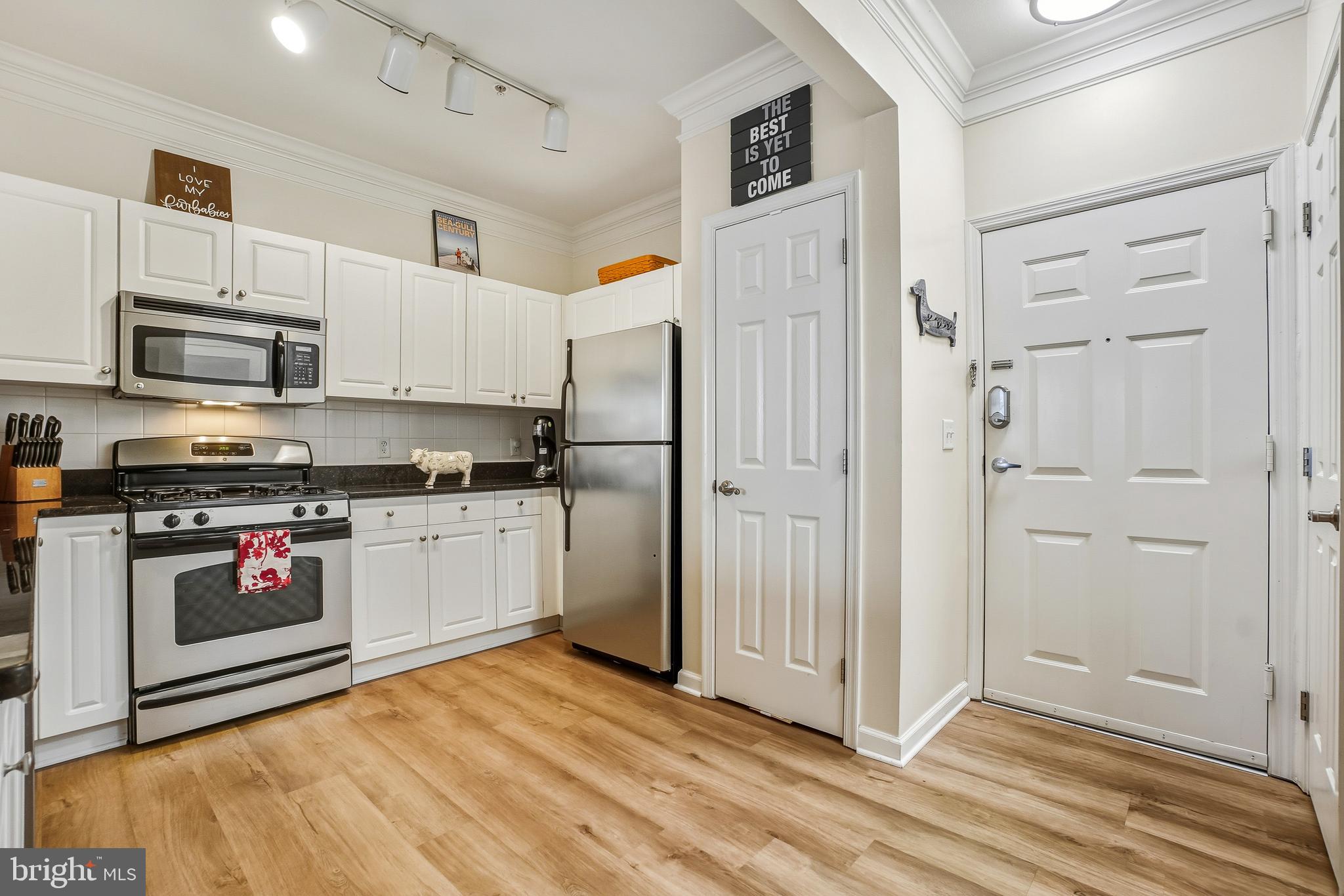 27 Booth Street, Unit 345 Gaithersburg, MD 20878 - Photo 5 of 40 a kitchen with stainless steel appliances a refrigerator stove and white cabinets