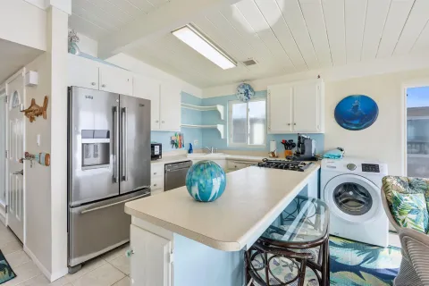 a kitchen with a refrigerator a stove top oven a sink and dishwasher