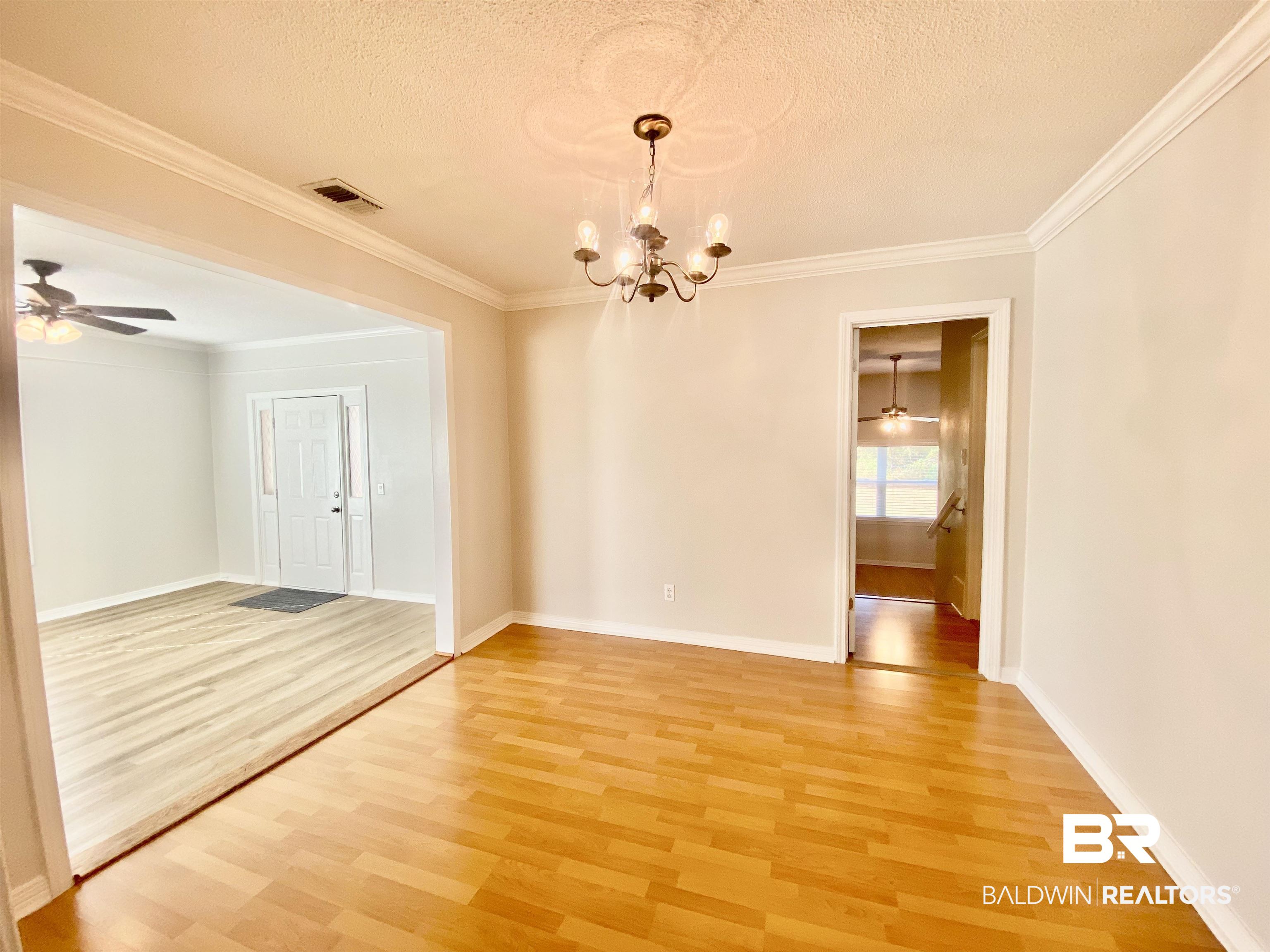 265 Azalea Drive Monroeville, AL 36460 - Photo 11 of 39 Spare room with a textured ceiling, hardwood / wood-style flooring, and ornamental molding