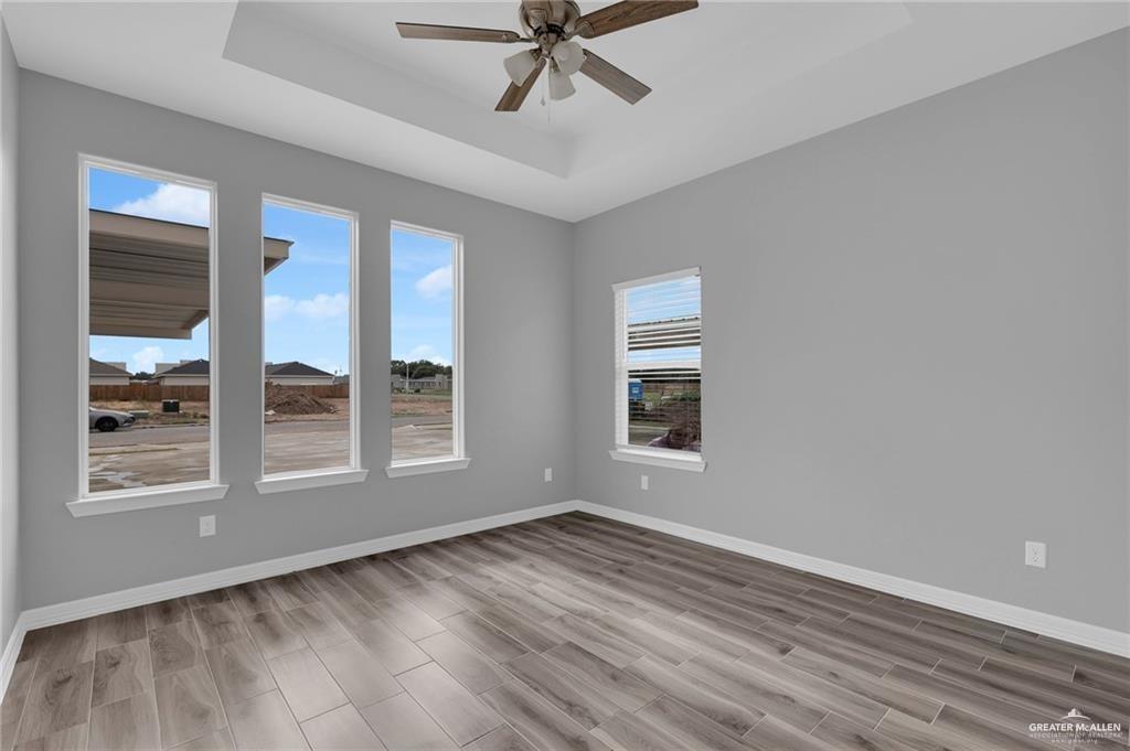 1318 San Vicente, Unit 4 Weslaco, TX 78596 - Photo 6 of 9 a view of an empty room with a window and wooden floor