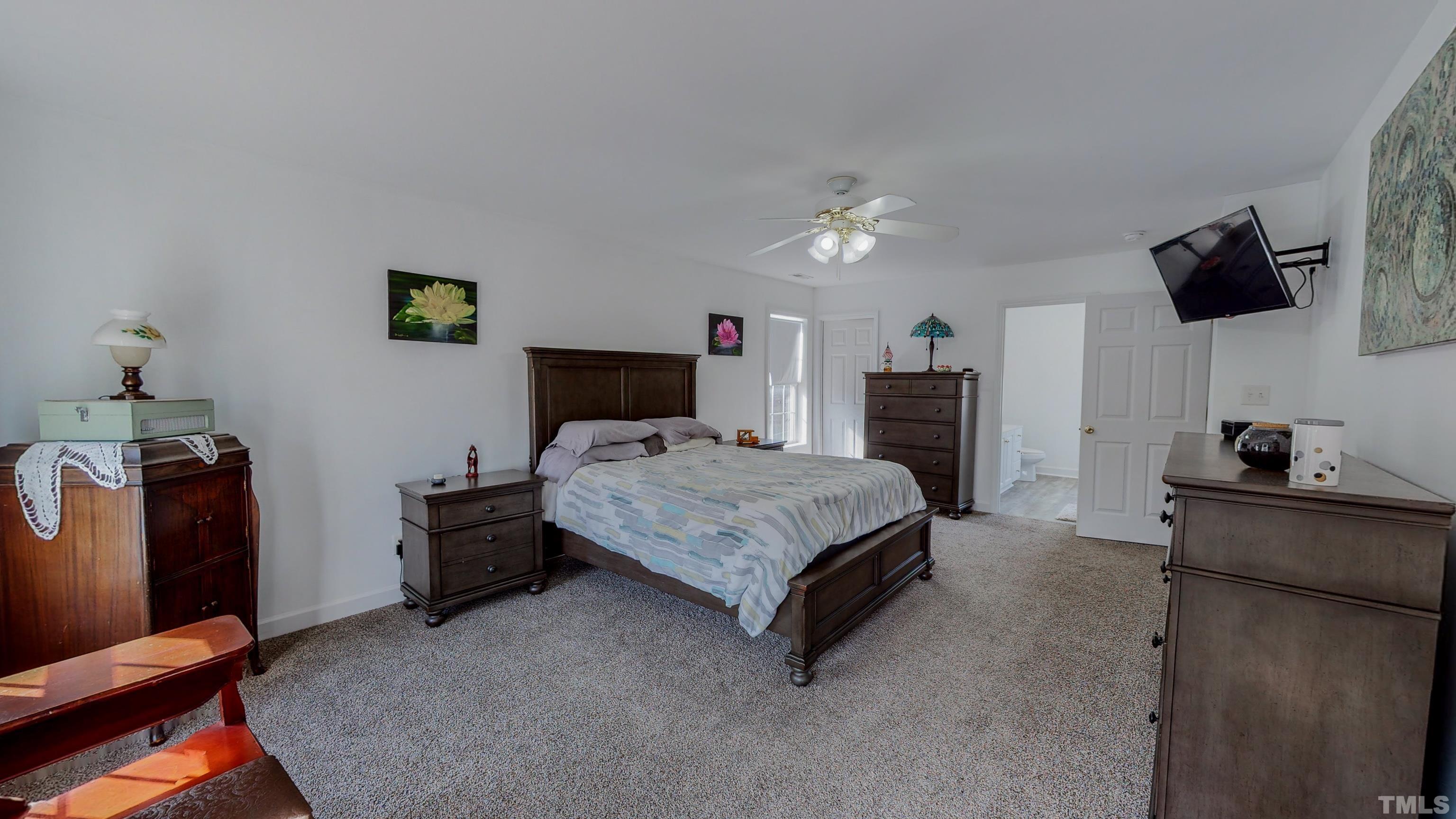 145 Deep Creek Point Rougemont, NC 27572 - Photo 18 of 52 a bedroom with a bed and flat screen tv