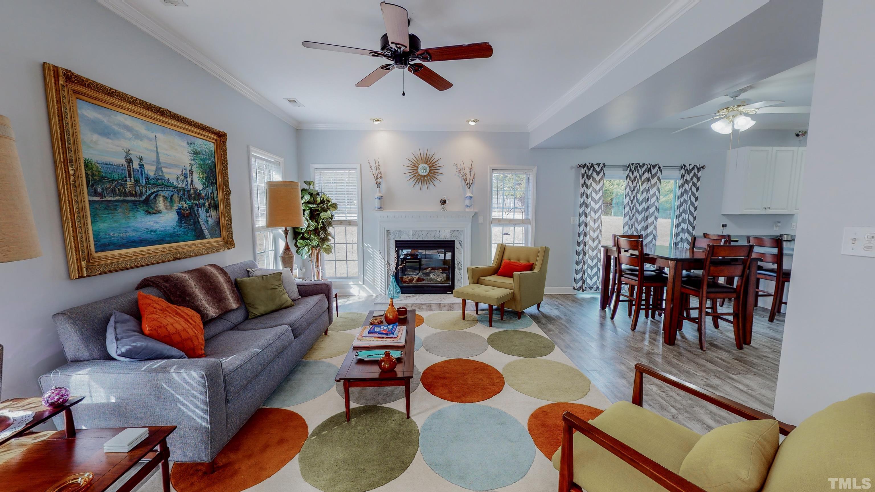 145 Deep Creek Point Rougemont, NC 27572 - Photo 2 of 52 a living room with furniture a fireplace and a chandelier