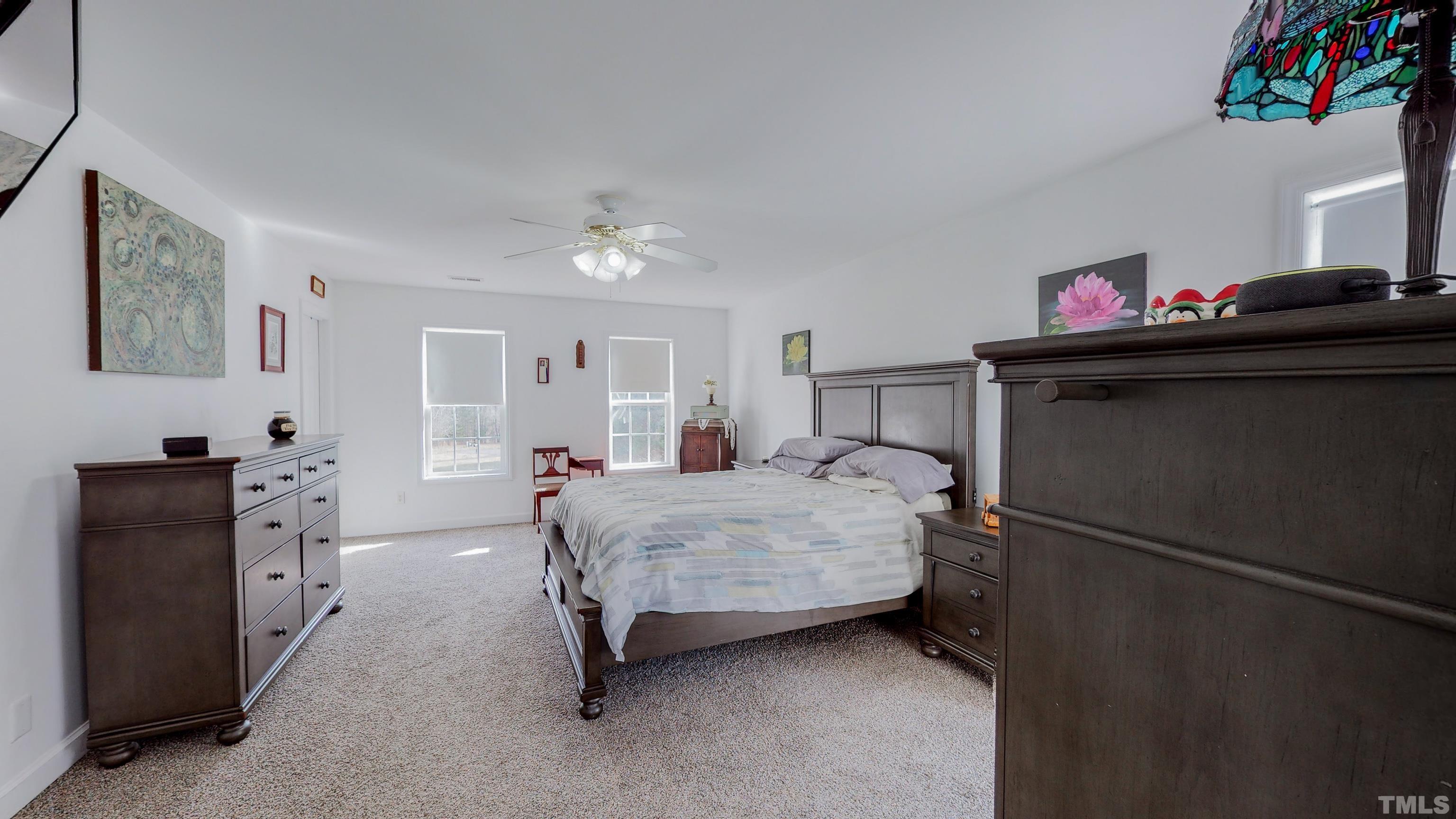 145 Deep Creek Point Rougemont, NC 27572 - Photo 21 of 52 a bedroom with a bed and a chandelier