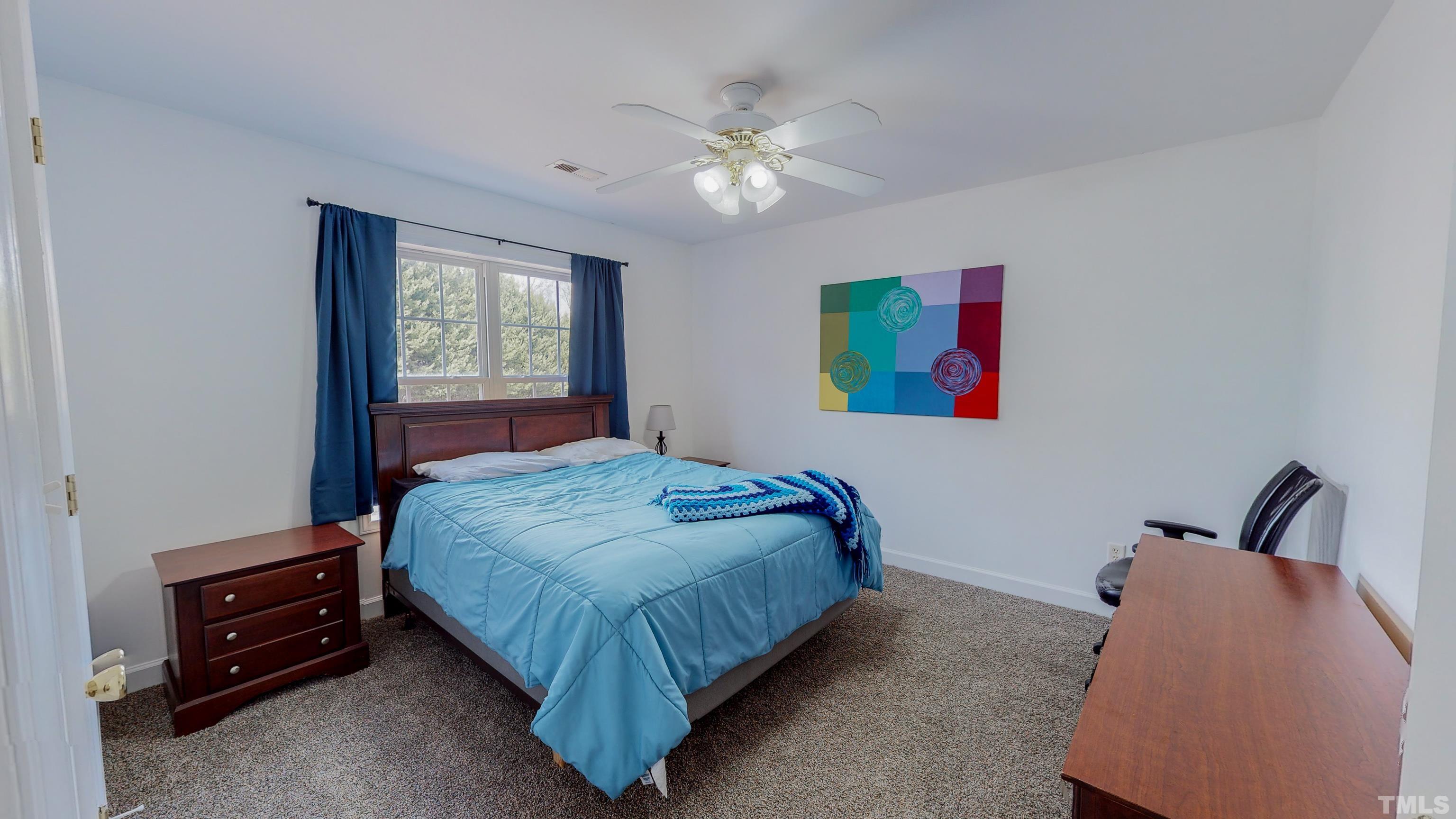 145 Deep Creek Point Rougemont, NC 27572 - Photo 29 of 52 a bedroom with a bed and a chandelier