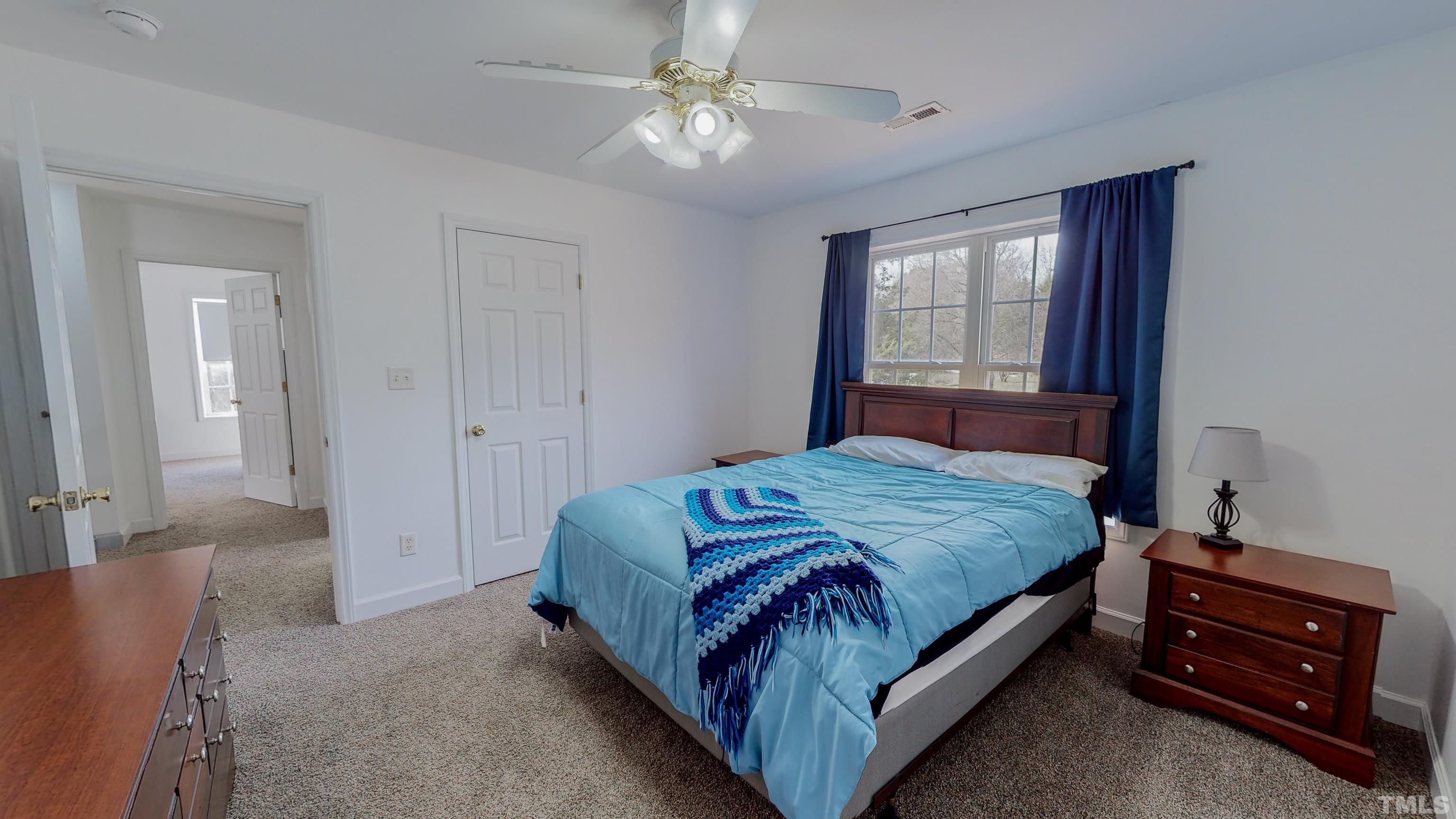 145 Deep Creek Point Rougemont, NC 27572 - Photo 30 of 52 a bedroom with a bed and a chandelier