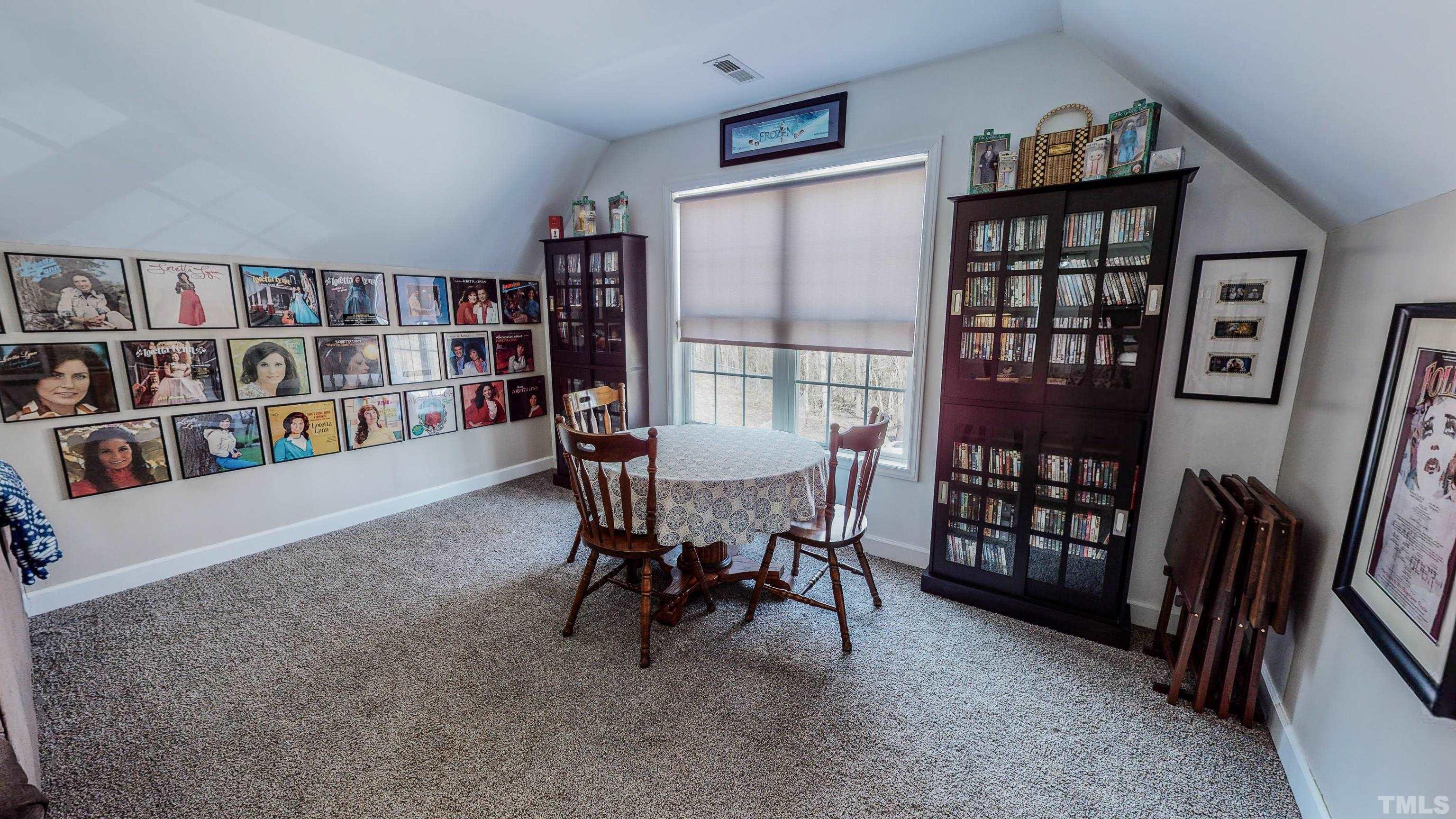 145 Deep Creek Point Rougemont, NC 27572 - Photo 35 of 52 a view of a livingroom with furniture and a bookshelf