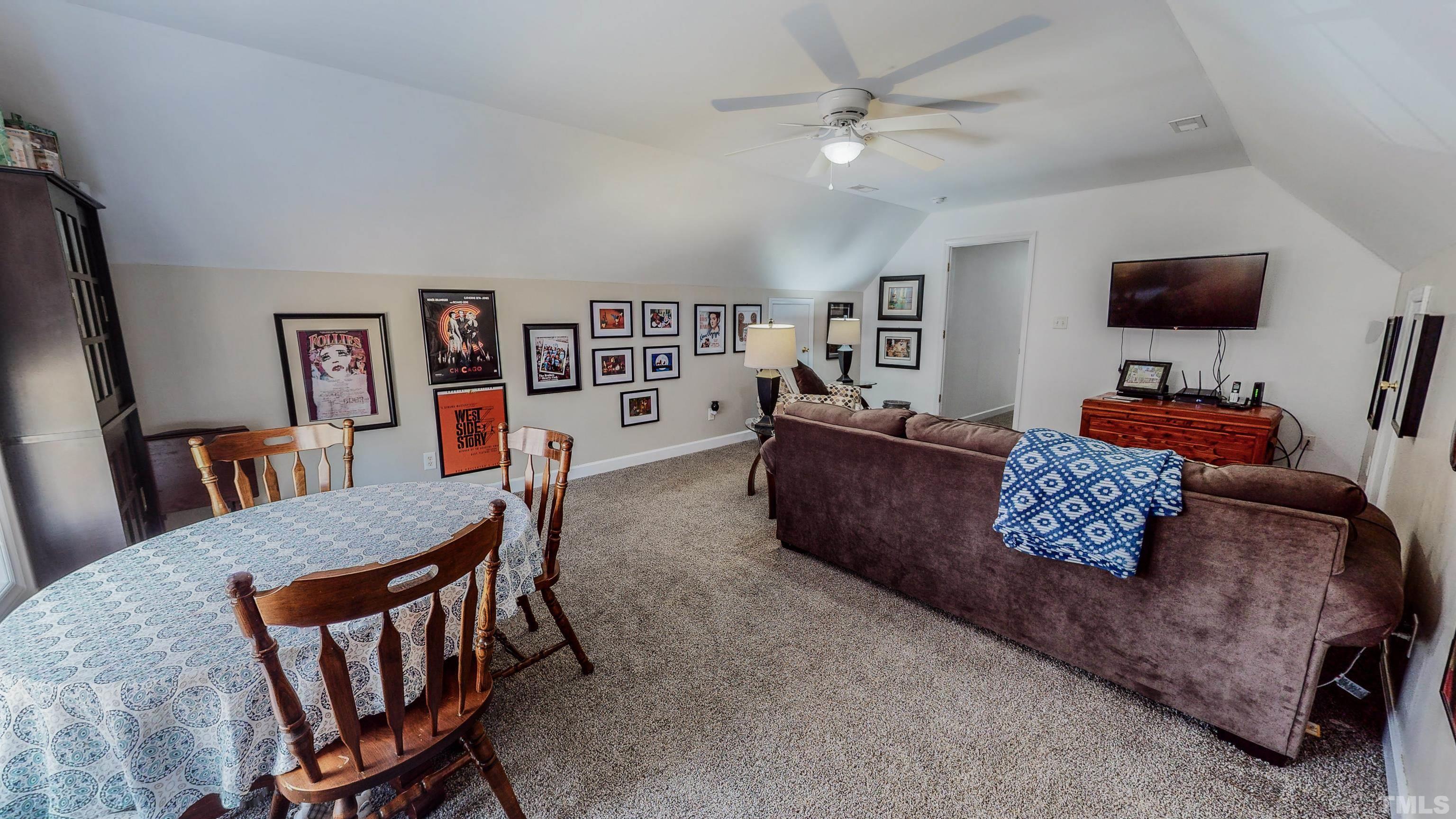 145 Deep Creek Point Rougemont, NC 27572 - Photo 36 of 52 a living room with furniture and a flat screen tv