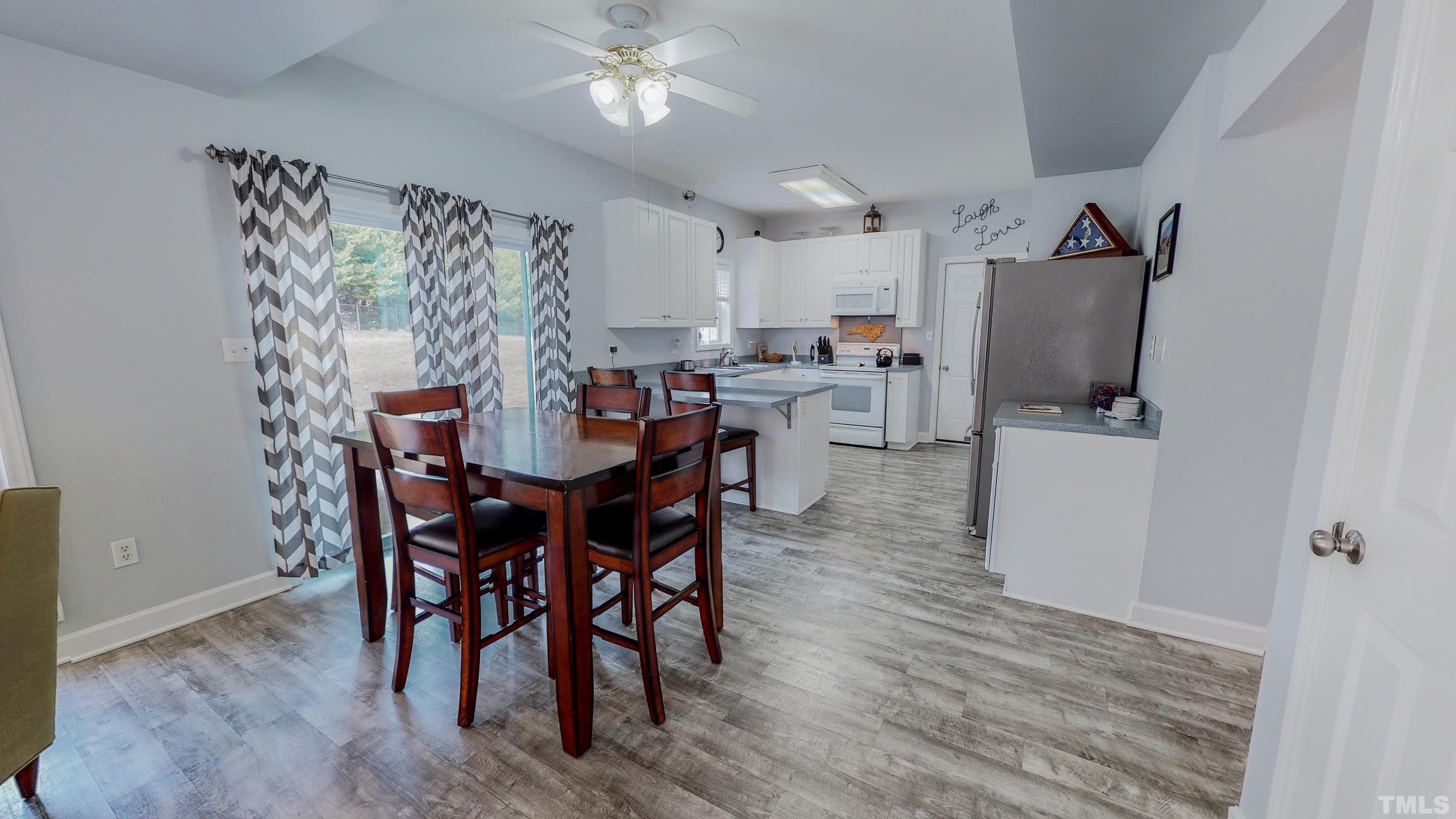 145 Deep Creek Point Rougemont, NC 27572 - Photo 4 of 52 a view of a dining room with furniture and wooden floor