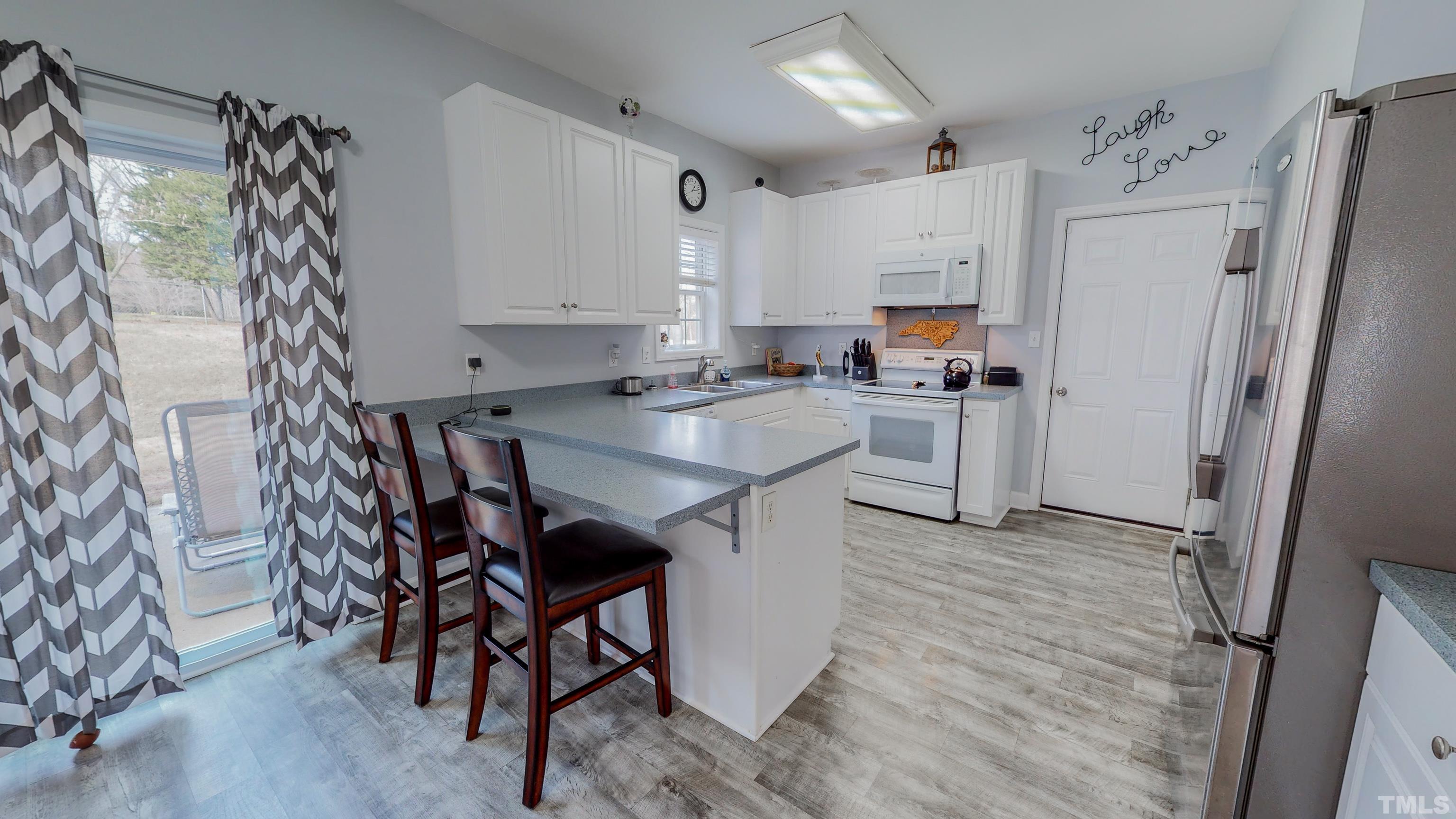 145 Deep Creek Point Rougemont, NC 27572 - Photo 5 of 52 a kitchen with stainless steel appliances granite countertop a refrigerator and a stove top oven