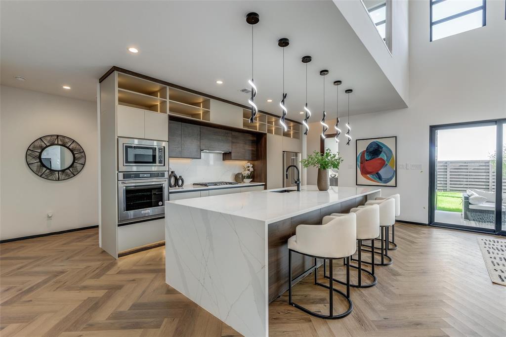 3601 Sky Rdg Lane Melissa, TX 75454 - Photo 18 of 31 a kitchen with stainless steel appliances granite countertop a kitchen island a stove a table and chairs in it