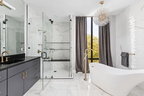 a bathroom with a granite countertop sink a mirror and shower