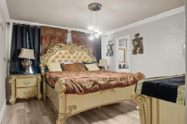 a bedroom with a bed and a chandelier