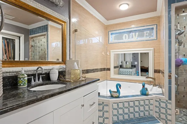a bathroom with a granite countertop sink and a large mirror