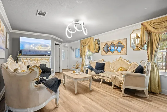 a living room with furniture and a chandelier