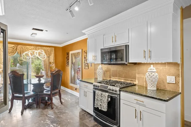 a bathroom with a granite countertop sink a toilet and shower