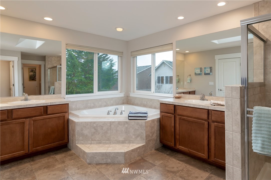 5225 Northeast 8th Place Renton, WA 98059 - Photo 22 of 38 a bathroom with a tub sink and mirror