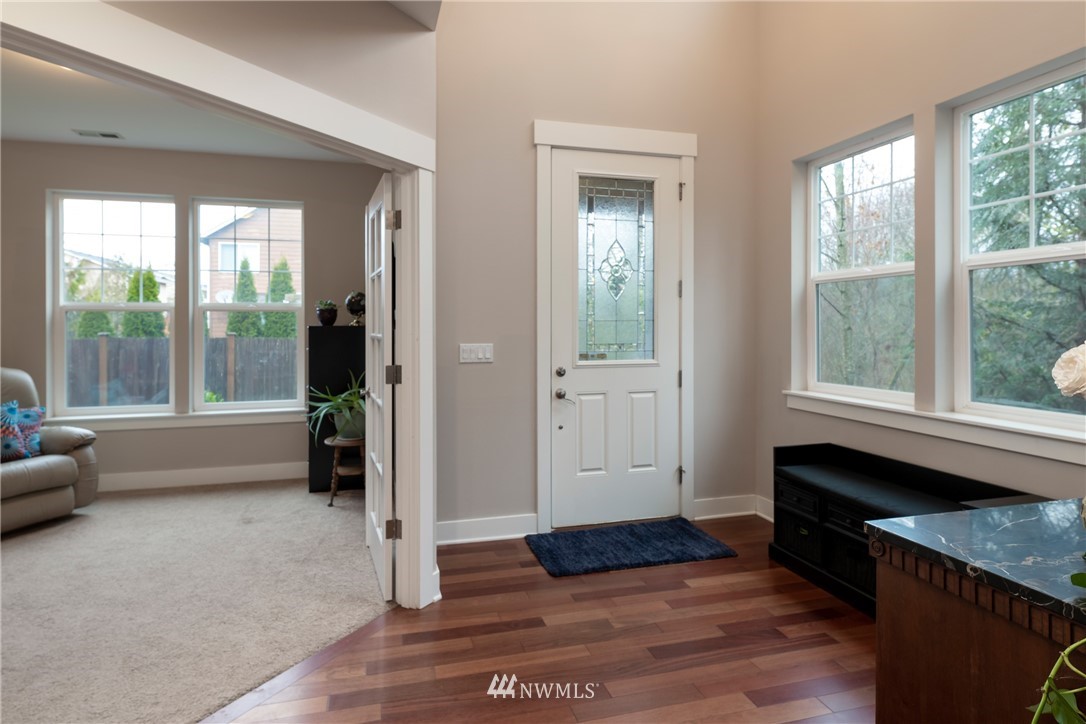 5225 Northeast 8th Place Renton, WA 98059 - Photo 4 of 38 a view of an entryway with wooden floor and a livingroom