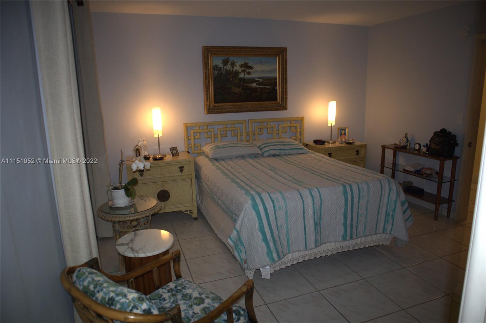 8625 Northwest 8th Street, Unit 420 Miami, FL 33126 - Photo 15 of 26 a bedroom with a bed and balcony view