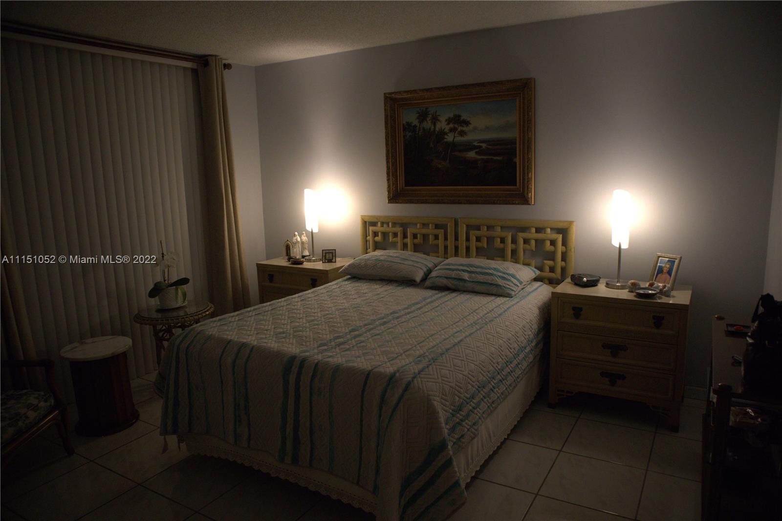 8625 Northwest 8th Street, Unit 420 Miami, FL 33126 - Photo 16 of 26 a bedroom with a bed and a window