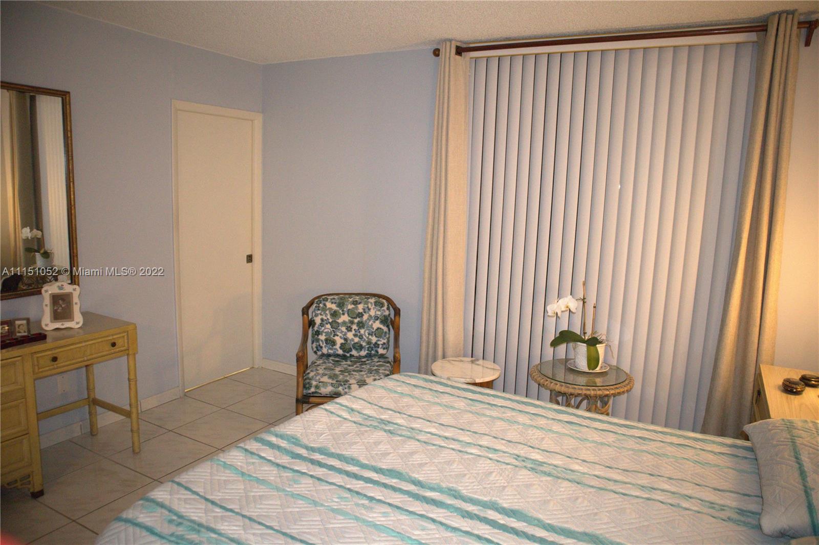 8625 Northwest 8th Street, Unit 420 Miami, FL 33126 - Photo 18 of 26 a bedroom with a bed and a dresser