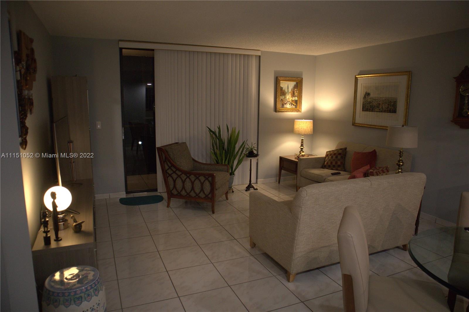 8625 Northwest 8th Street, Unit 420 Miami, FL 33126 - Photo 2 of 26 a living room with furniture and a fan