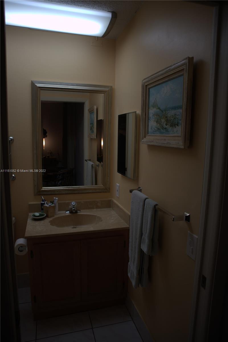 8625 Northwest 8th Street, Unit 420 Miami, FL 33126 - Photo 21 of 26 a bathroom with a sink vanity and a mirror